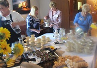 Women standing around table serving tea