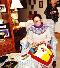 seated woman stitching
